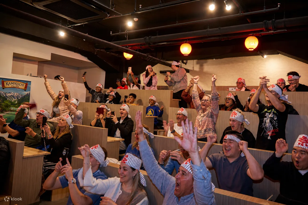 International guests cheering during the sumo show