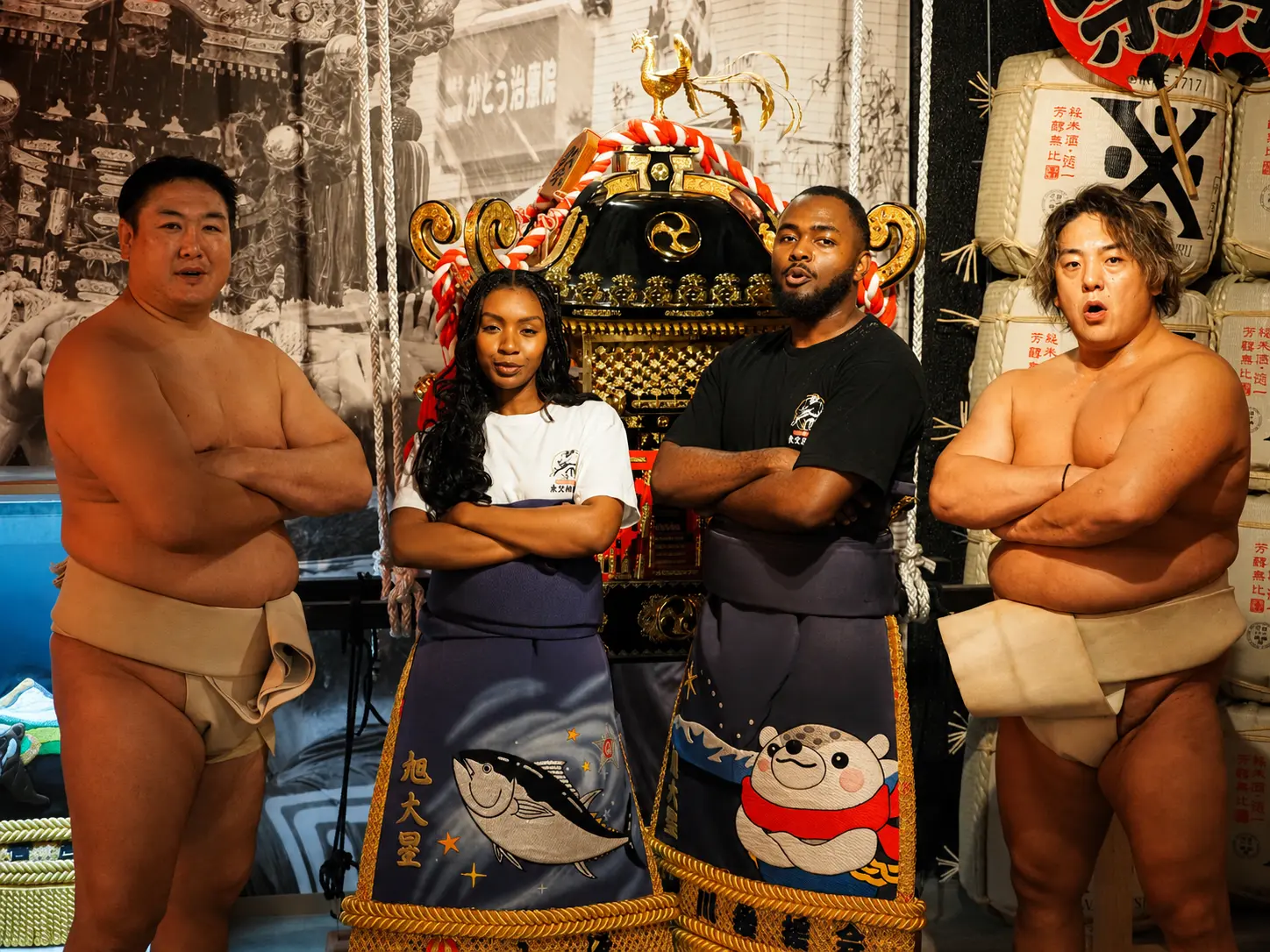 Tokyo Sumo Festival performers posing in front of an ornate mikoshi