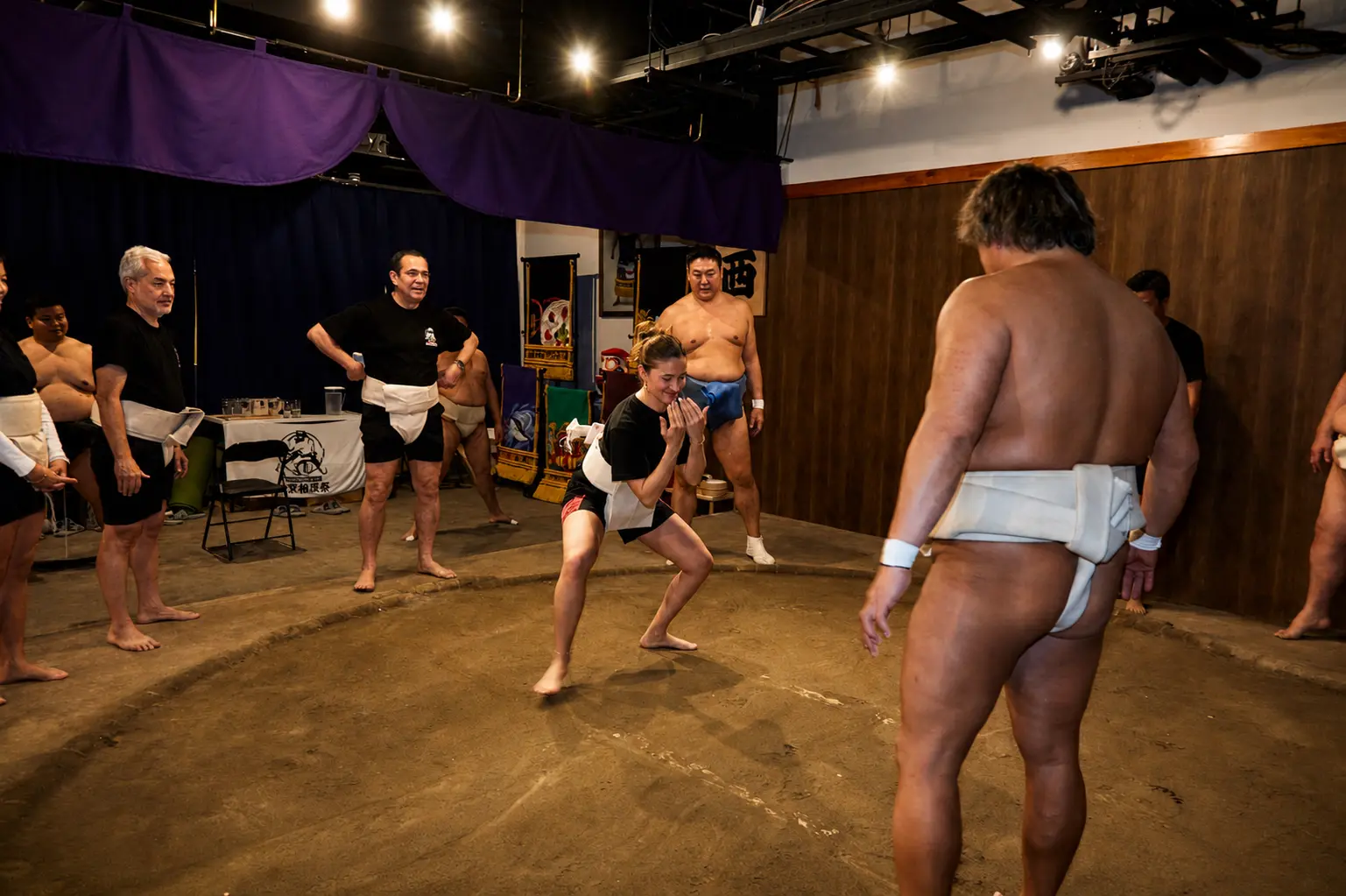 A guest learning authentic sumo movements on the dohyo